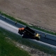 Asphalte JRL Paving grader, truck and roller on road aerial view